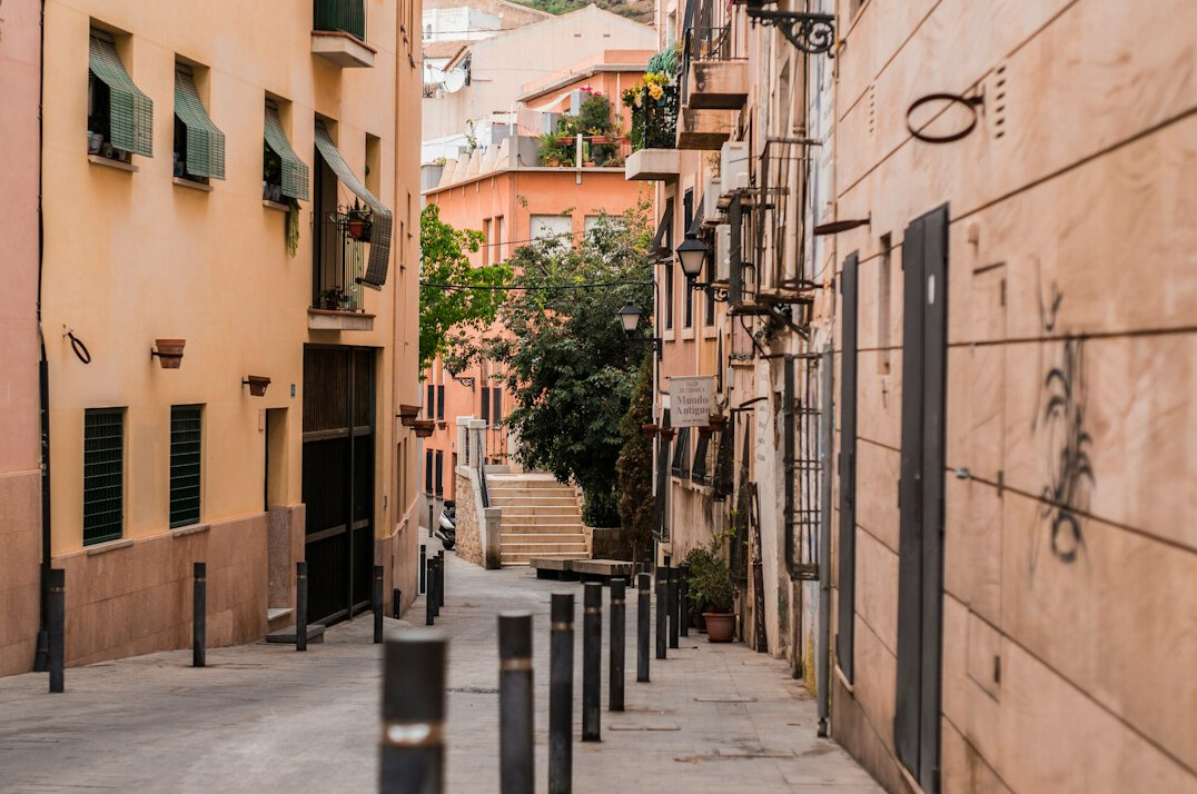 Narrow city alley with fire escapes and parked bicycles